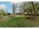Expansive backyard featuring a charming brick home and lush green lawn at 1345 Laredo St, Aurora, CO 80011