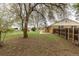 Spacious backyard featuring mature trees, lawn, and a covered patio, with a view of a charming single-Gathering home at 1345 Laredo St, Aurora, CO 80011