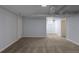 Spacious basement features carpeted floor, utility pipes, and a secure window, offering versatile use potential at 1345 Laredo St, Aurora, CO 80011