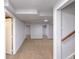 The basement features carpeted floors and multiple doorways leading to other rooms in the basement at 1345 Laredo St, Aurora, CO 80011