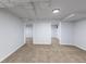 Spacious finished basement with carpeted floors, painted walls, and open doorways to other rooms at 1345 Laredo St, Aurora, CO 80011