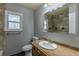 Bathroom with single sink vanity, toilet, and shower with decorative tile at 1345 Laredo St, Aurora, CO 80011