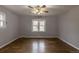 Bright bedroom with hardwood floors, ceiling fan, and plenty of natural light from two windows at 1345 Laredo St, Aurora, CO 80011