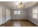 Bright bedroom with hardwood floors, ceiling fan, and plenty of natural light from two windows at 1345 Laredo St, Aurora, CO 80011