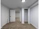 Neutral bedroom features carpeted floor, closet, and a view into another room, offering a comfortable space at 1345 Laredo St, Aurora, CO 80011