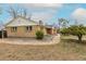 Charming single-story brick home with a neatly paved walkway and a manicured garden area under a partly cloudy sky at 1345 Laredo St, Aurora, CO 80011