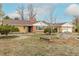Single Gathering home with brick exterior, an attached two car garage, and mature landscaping at 1345 Laredo St, Aurora, CO 80011