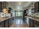 Well-lit kitchen with sleek black cabinets, tile backsplash, and stainless steel appliances at 1345 Laredo St, Aurora, CO 80011