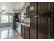 Bright kitchen featuring dark wood cabinets, stainless appliances, and a window view at 1345 Laredo St, Aurora, CO 80011