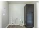 Laundry room with gray walls, tile floors, and black storage cabinet at 1345 Laredo St, Aurora, CO 80011