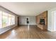 Open concept living room featuring hardwood floors, brick fireplace, neutral colored walls and lots of light at 1345 Laredo St, Aurora, CO 80011