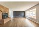 Bright living room features a brick fireplace, hardwood floors, and a large picture window for natural light at 1345 Laredo St, Aurora, CO 80011