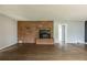 Living room showcasing a brick fireplace, hardwood floors, and neutral colored walls with a large window at 1345 Laredo St, Aurora, CO 80011