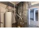 Utility room featuring a water heater, furnace, and other mechanical equipment and access to the basement at 1345 Laredo St, Aurora, CO 80011