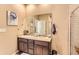 Bathroom features a double vanity, spacious mirror, and a shower with white tile surround at 6045 High Timber Cir, Castle Rock, CO 80104