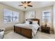 Bright bedroom with a wooden bed frame, ceiling fan, and large windows offering ample natural light at 6045 High Timber Cir, Castle Rock, CO 80104