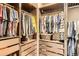 Walk-in closet featuring custom shelving, drawers, and hanging rods at 6045 High Timber Cir, Castle Rock, CO 80104