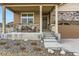 Welcoming front porch with seating and stylish stone accents, highlighting the home's entrance at 6045 High Timber Cir, Castle Rock, CO 80104