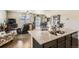 Open floor plan showcases a modern kitchen with island seating, seamlessly connecting to the living area at 6045 High Timber Cir, Castle Rock, CO 80104
