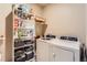 Laundry room featuring a washer and dryer, shelving, and space for storage at 6045 High Timber Cir, Castle Rock, CO 80104