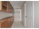 Long basement hallway with built in storage and white door at 3912 S Richfield Way, Aurora, CO 80013