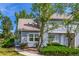 Well-maintained gray townhome with mature trees, landscaped front yard, and a welcoming entrance at 3912 S Richfield Way, Aurora, CO 80013