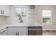 Bright kitchen features a large sink, stainless steel dishwasher, and modern finishes at 3912 S Richfield Way, Aurora, CO 80013