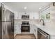 Updated kitchen with stainless steel appliances and quartz countertops at 3912 S Richfield Way, Aurora, CO 80013