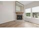 Cozy living room featuring a stone fireplace, hardwood floors, and bright natural light at 3912 S Richfield Way, Aurora, CO 80013