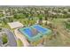 Aerial view of community tennis and basketball courts and a walking trail in a lush community at 3056 Yale Dr, Broomfield, CO 80023