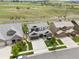 An aerial view of a house with neutral colors, a driveway, and green grass surrounding the home at 3056 Yale Dr, Broomfield, CO 80023
