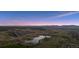Scenic aerial view of mountains and a lake at sunset in a sprawling community at 3056 Yale Dr, Broomfield, CO 80023