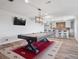 Basement rec room with a pool table, bar seating, and a TV for entertainment, perfect for gatherings at 3056 Yale Dr, Broomfield, CO 80023
