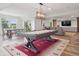 Spacious finished basement with a pool table, living area, and dining set at 3056 Yale Dr, Broomfield, CO 80023