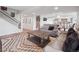 Open basement living area with a lounge area, a dart board, and stairs leading to the upper level at 3056 Yale Dr, Broomfield, CO 80023