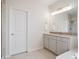 Bright bathroom features a spacious vanity with granite countertop, tiled floors, and modern fixtures at 3056 Yale Dr, Broomfield, CO 80023