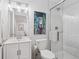 Bathroom featuring a vanity with white cabinets, shower with glass door and bright lighting at 3056 Yale Dr, Broomfield, CO 80023