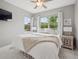 Bright bedroom features a ceiling fan, natural light, and neutral decor at 3056 Yale Dr, Broomfield, CO 80023