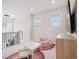 Cozy bonus room with neutral walls, three windows, recessed lighting, and a tv at 3056 Yale Dr, Broomfield, CO 80023