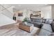 Open concept view of staircase, living room with a sofa and view to the kitchen at 3056 Yale Dr, Broomfield, CO 80023
