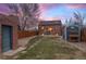 Landscaped backyard with shed, stone path, and grassy area at 3633 N Cook St, Denver, CO 80205