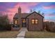 Brick home with a charming front porch and well-manicured lawn at 3633 N Cook St, Denver, CO 80205