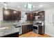 Modern kitchen with dark wood cabinets and stainless steel appliances at 3633 N Cook St, Denver, CO 80205