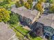 An aerial view showcases townhomes with patios, fenced yards, mature trees, and well-maintained landscaping at 6135 S Paris St, Englewood, CO 80111