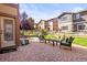 Inviting backyard patio with a comfortable seating area, lush grass, and a wooden fence at 6135 S Paris St, Englewood, CO 80111