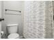 Bathroom featuring a toilet with a white textured shower curtain at 6135 S Paris St, Englewood, CO 80111