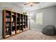 Bedroom featuring a large bookcase, window with shutters, a floor lamp and a beanbag chair at 6135 S Paris St, Englewood, CO 80111