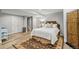 Bedroom featuring a bed with white linens, a rug, and access to the stairs at 6135 S Paris St, Englewood, CO 80111