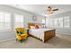 Serene bedroom featuring a wooden bed frame, bright windows, and comfortable seating at 6135 S Paris St, Englewood, CO 80111