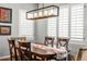 Dining room with bright windows and a wooden table with seating for six at 6135 S Paris St, Englewood, CO 80111